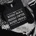 Wears black crew neck sweatshirt